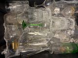 a pile of empty plastic bottles sitting on a table