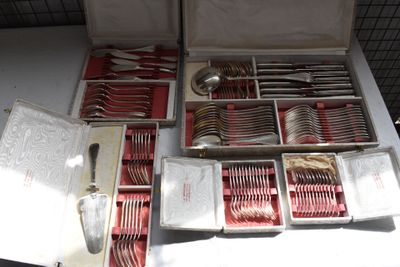 a box of silverware on a table with other silverware in it