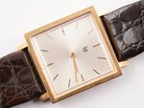 a close up of a wrist watch with a brown leather strap