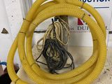 a yellow hose sitting on top of a table next to a sign