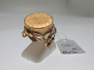 an image of a gold ring with a flower design on it
