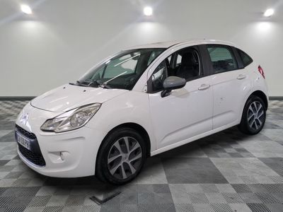 the white citrole is parked on a checkered floor