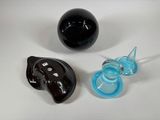 two black and blue glass objects on a white surface