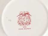 a white plate with a red design on it