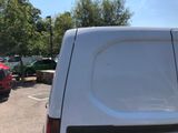 a white van parked in a parking lot with other cars in the background