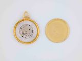 a close up of a gold pocket watch with a white background