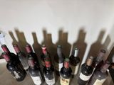 many bottles of wine sitting on a table