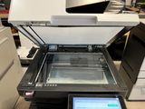 a printer that is sitting on a desk next to a laptop