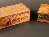 deux boîtes en bois ornées de motifs décoratifs, posées sur une table