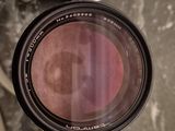 a camera lens sitting on top of a table next to a cup of coffee