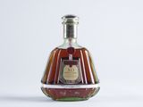 a bottle of brandy sitting on a white surface