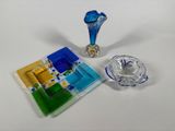 a glass ashtray and a glass ashtray on a white table