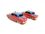 two red and blue toy cars on a white surface