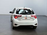 the rear of a white toyota yaris parked in a white room
