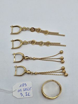 a close up of a bunch of gold jewelry on a table