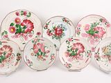 plusieurs assiettes ornées de motifs floraux, posées sur une surface blanche