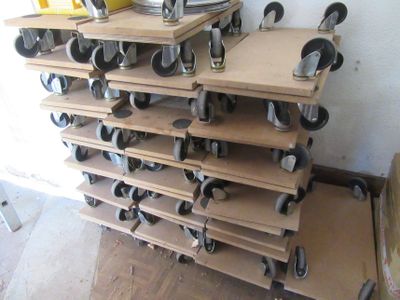 a stack of shelves with wheels on them in a room