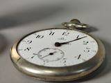 a close up of a pocket watch on a table
