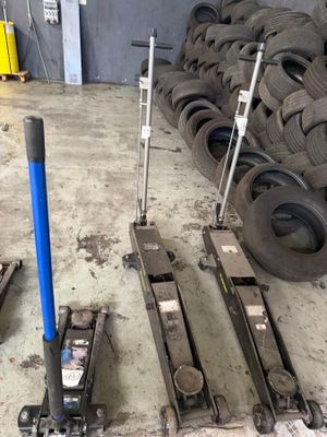 a pile of tires and a blue pole in a warehouse