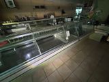 an image of a restaurant with a counter and a glass case