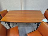 an image of a wooden table with four chairs around it