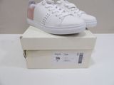 a white and pink sneaker on top of a box