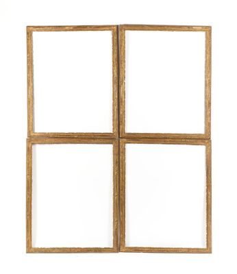 four square wooden frames on a white wall with a white background