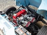a blue car with a red engine in the back