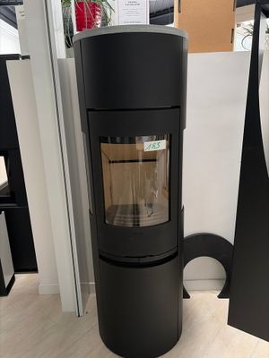 the large black stove is in the corner of the room