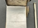 a pen and a piece of paper sitting on a table