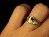 a person ' s hand with a ring on it
