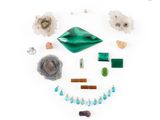 a close up of a group of jewelry on a white surface