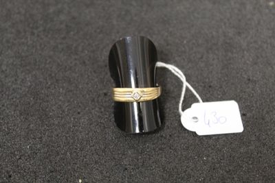 a ring with a diamond on it sitting next to a price tag