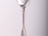 a spoon and a spoon rest on a white surface