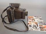 an old camera and a magazine on a table