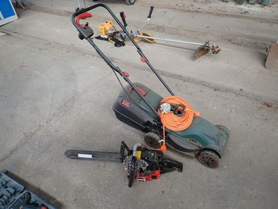 a lawn mower that is laying on the ground
