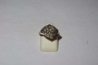 a close up of a silver ring on a white surface