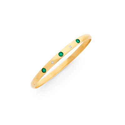 un pendentif en or jaune orné d'émeraudes