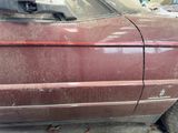 a dirty car that is parked on the side of the street