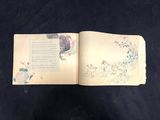 an open book with a picture of a rooster on it