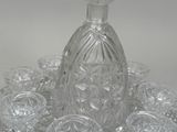 many glasses and a decanter sitting on a table