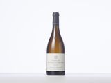 a bottle of white wine sitting on top of a table