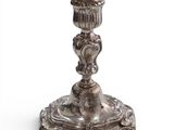 a silver candle holder with a bird on it
