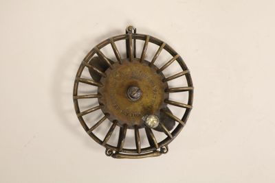 a small metal object that is hanging on the wall