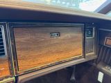a dashboard of a car with wood paneling on it