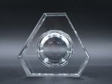 a glass clock that is on display on a table