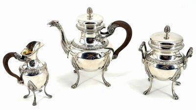 three pieces of silver tea and coffee set on a white background