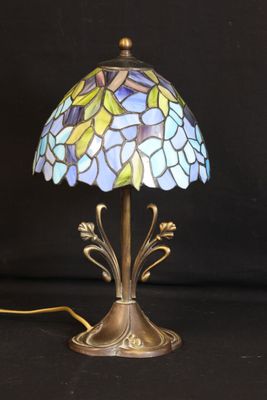 a close up of a lamp on a table with a black background