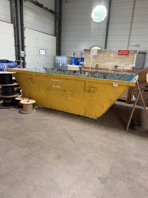 a yellow boat that is sitting in a warehouse