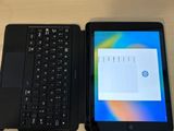 two laptops sitting next to each other on a table